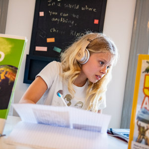 Girl studying with headphones on