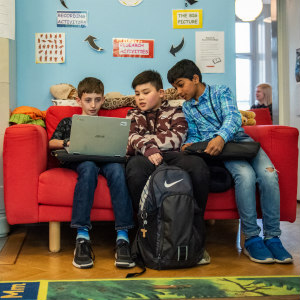 Students gathered around a laptop