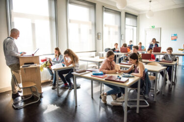 A school classroom with students working at their desks