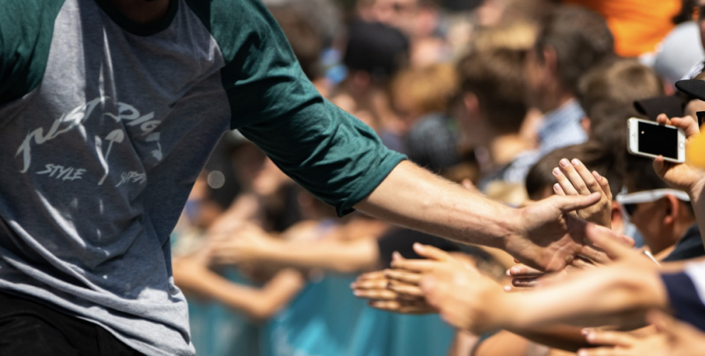 Image of celebrity shaking hands with a crowd