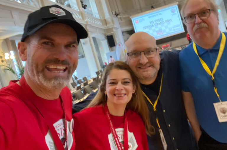 Ryan (left) and Katalin with officals as SIS hosted a Junior Grand Prix tournament last year